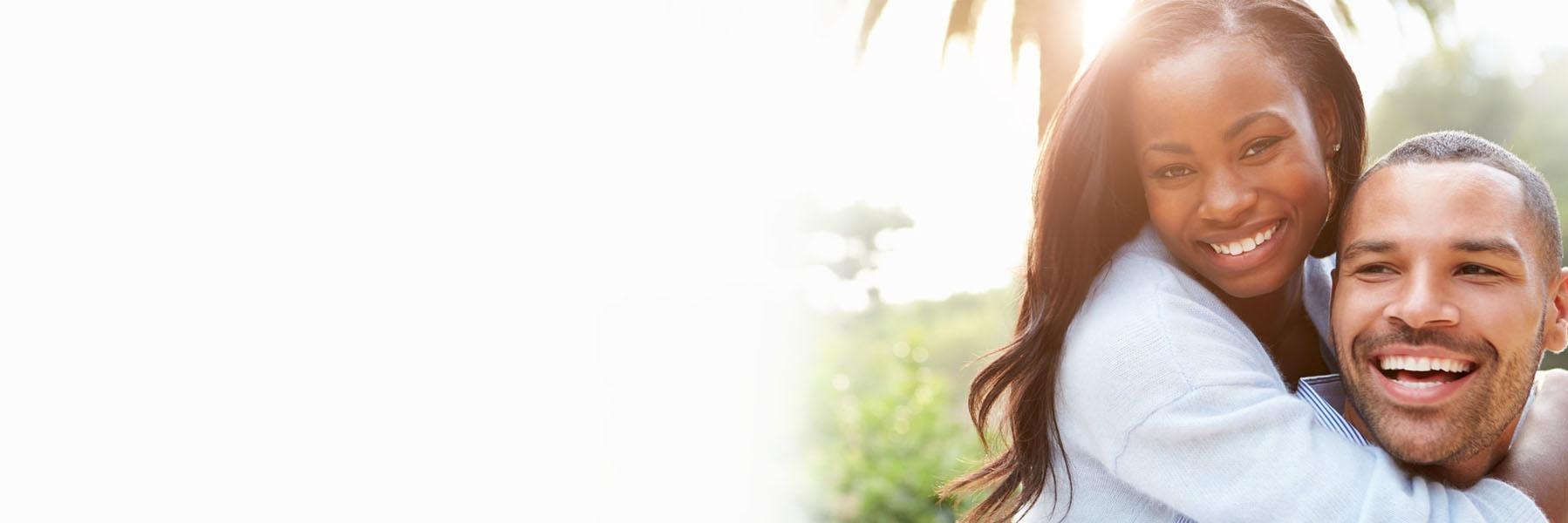 Couple laughing after replacing missing teeth in Beachwood, OH 