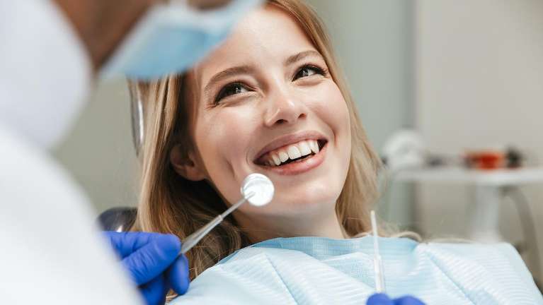 Lady undergoing dental cleaning in Beachwood, Ohio