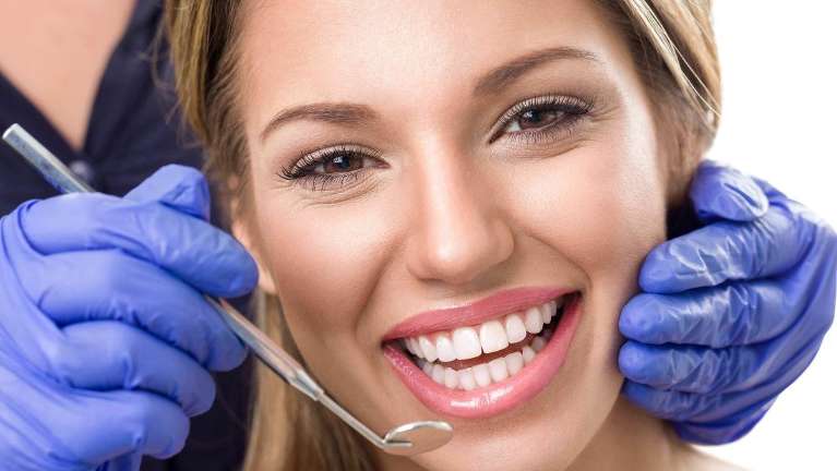 A lady smiling after teeth whitening in Beachwood, OH.